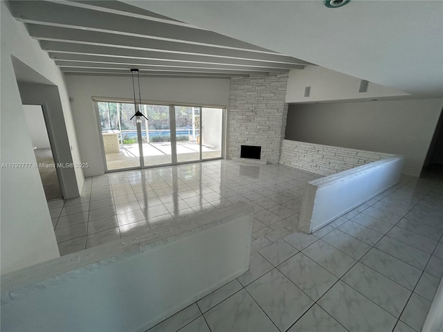 unfurnished living room with tile patterned flooring, lofted ceiling with beams, and a fireplace