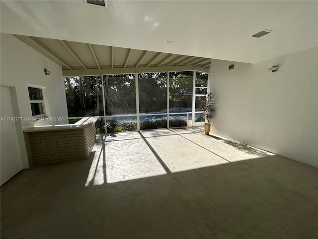 interior space featuring plenty of natural light and beam ceiling