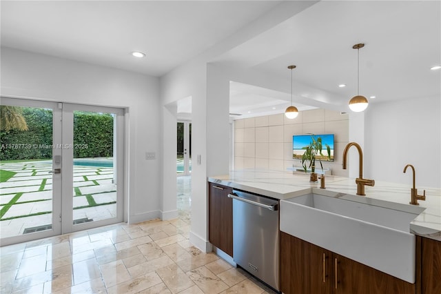 kitchen with stainless steel dishwasher, light stone countertops, recessed lighting, a sink, and decorative light fixtures
