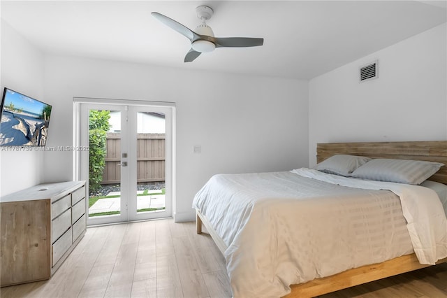 bedroom featuring visible vents, light wood-style floors, ceiling fan, and access to exterior