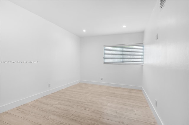 unfurnished room featuring light wood-type flooring, recessed lighting, and baseboards