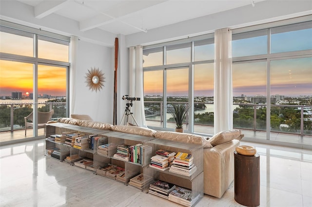 tiled living area with a city view and beam ceiling