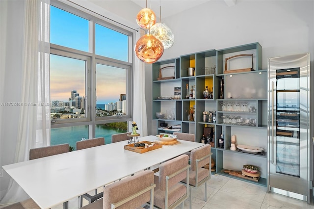 dining room with beverage cooler, a city view, and marble finish floor