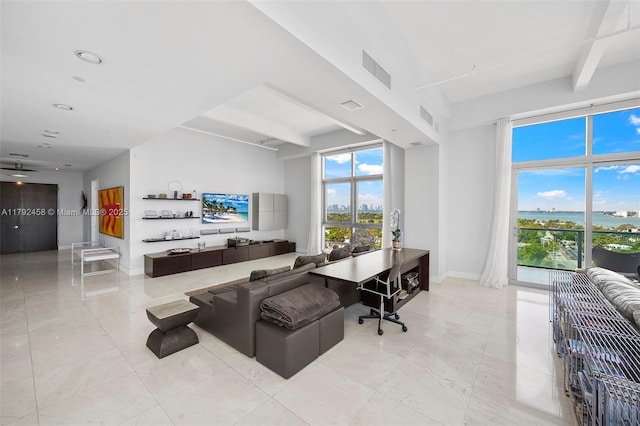 living area featuring visible vents, baseboards, and beamed ceiling