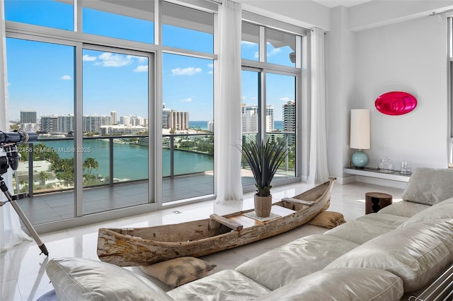 living room featuring a water view and a city view