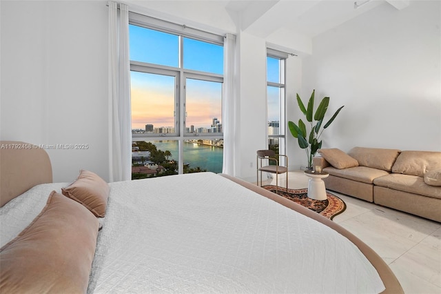 bedroom with a city view and a water view