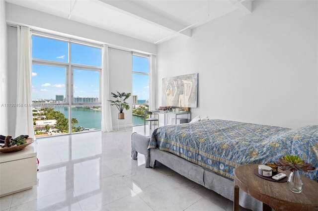 bedroom featuring a water view and beam ceiling