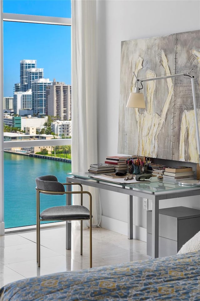 bedroom with a water view and a view of city