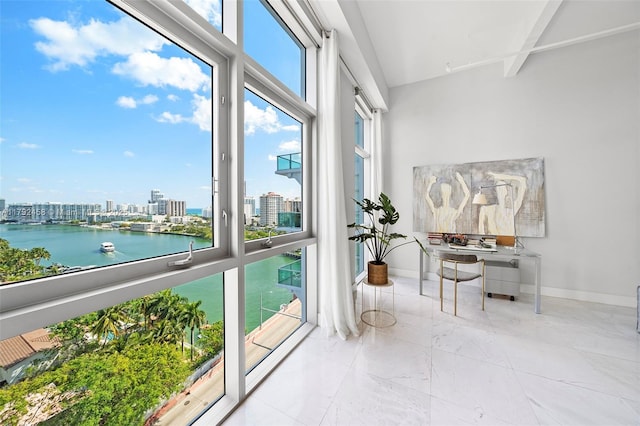 sunroom / solarium with a water view and a city view