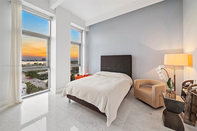 bedroom featuring a high ceiling and marble finish floor