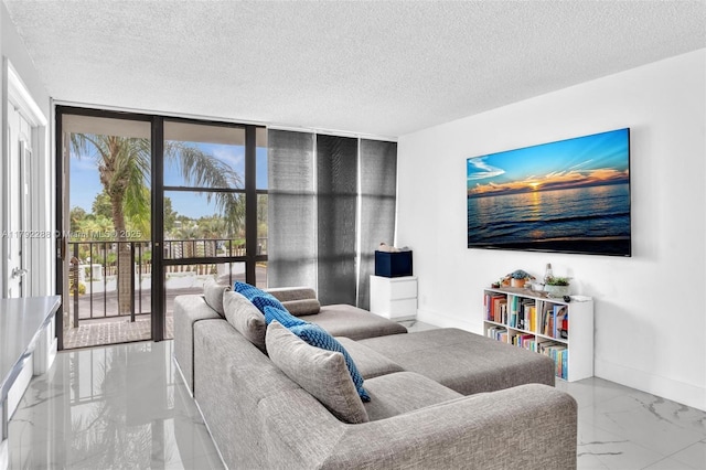 1000 Parkview Dr Unit 329, Hallandale Beach, FL 33009 - living area featuring a textured ceiling, floor to ceiling windows, baseboards, and marble finish floor