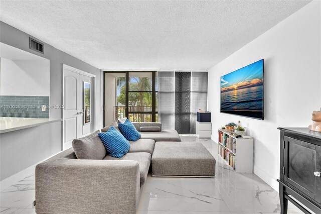 1000 Parkview Dr Unit 329, Hallandale Beach, FL 33009 - living room with baseboards, visible vents, a textured ceiling, and marble finish floor