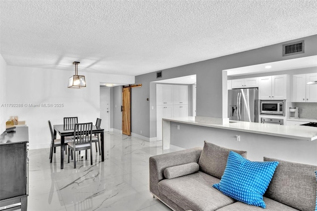 1000 Parkview Dr Unit 329, Hallandale Beach, FL 33009 - living area featuring marble finish floor, a textured ceiling, and visible vents