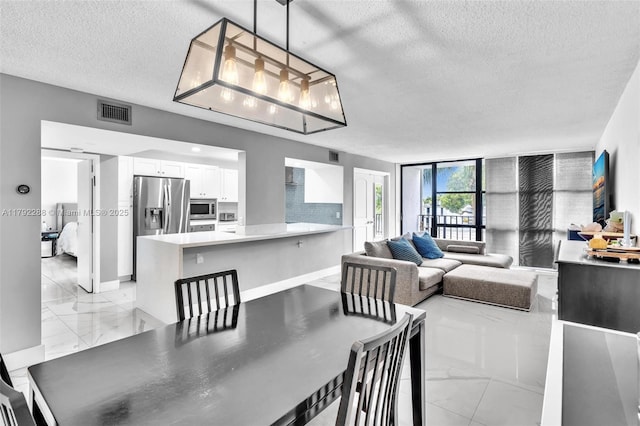 1000 Parkview Dr Unit 329, Hallandale Beach, FL 33009 - dining room featuring visible vents, marble finish floor, and a textured ceiling
