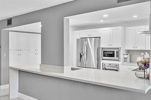 1000 Parkview Dr Unit 329, Hallandale Beach, FL 33009 - kitchen featuring visible vents, light stone counters, baseboards, stainless steel appliances, and white cabinetry