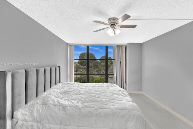 1000 Parkview Dr Unit 329, Hallandale Beach, FL 33009 - bedroom featuring expansive windows, a textured ceiling, baseboards, and radiator
