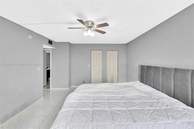 1000 Parkview Dr Unit 329, Hallandale Beach, FL 33009 - bedroom featuring a ceiling fan, visible vents, baseboards, marble finish floor, and multiple closets