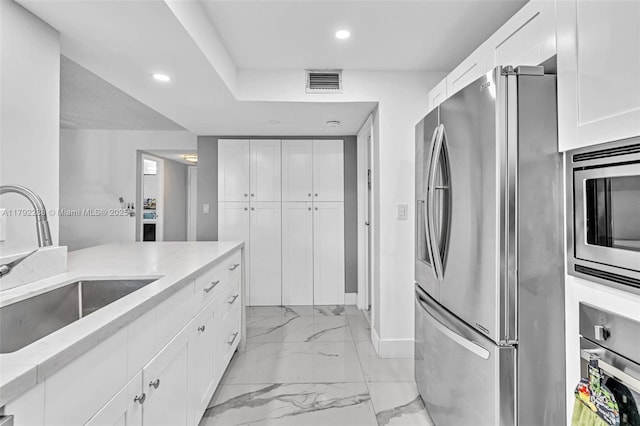 1000 Parkview Dr Unit 329, Hallandale Beach, FL 33009 - kitchen featuring appliances with stainless steel finishes, a sink, marble finish floor, recessed lighting, and visible vents