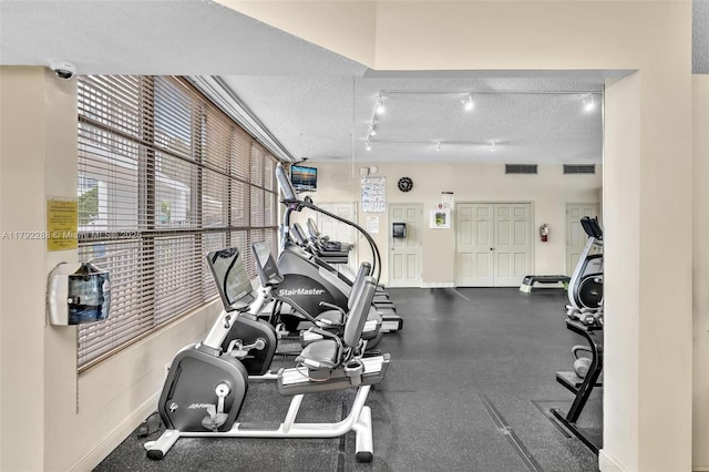 1000 Parkview Dr Unit 329, Hallandale Beach, FL 33009 - exercise room featuring baseboards, a textured ceiling, and visible vents