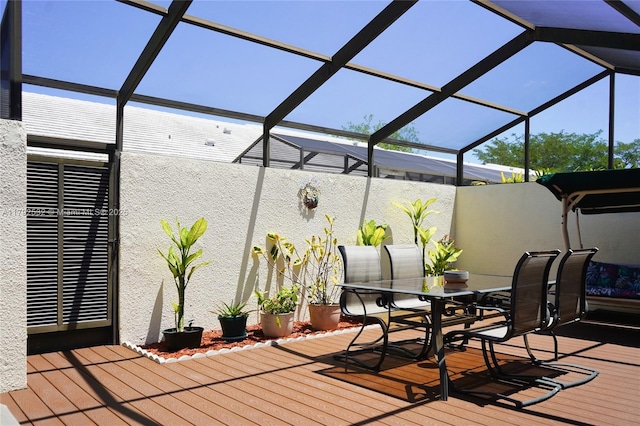wooden deck featuring a lanai and outdoor dining space