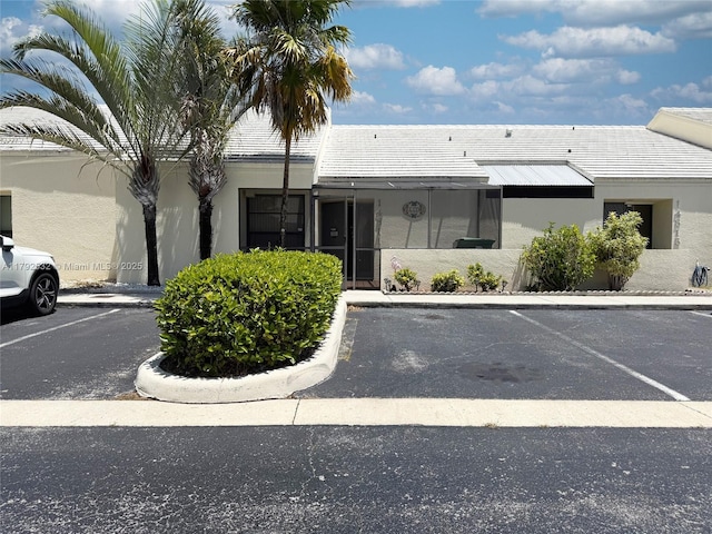 view of building exterior featuring uncovered parking