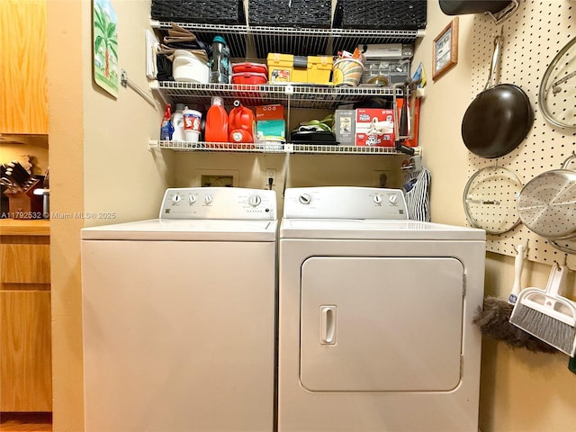 washroom featuring separate washer and dryer and laundry area