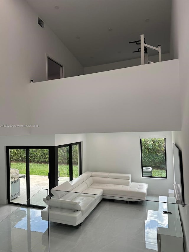 6711 SW 127th Pl, Miami, FL 33183 - living room with light tile patterned floors, a high ceiling, and visible vents