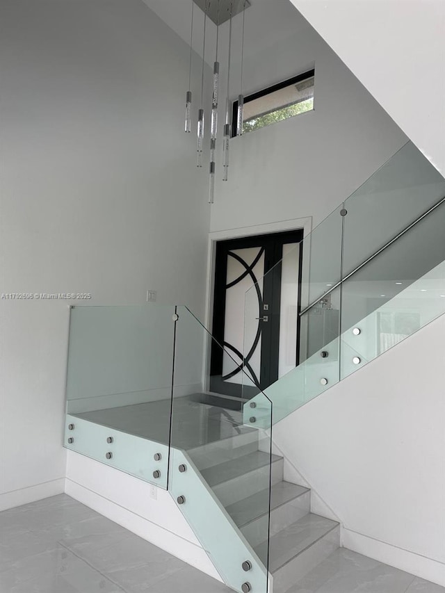 6711 SW 127th Pl, Miami, FL 33183 - stairs featuring baseboards, marble finish floor, and a towering ceiling