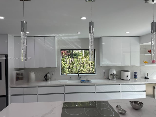 6711 SW 127th Pl, Miami, FL 33183 - kitchen with modern cabinets, black electric stovetop, white cabinets, tasteful backsplash, and a sink