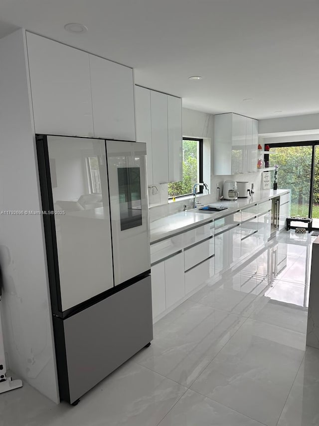 6711 SW 127th Pl, Miami, FL 33183 - kitchen featuring freestanding refrigerator, a sink, modern cabinets, and white cabinets