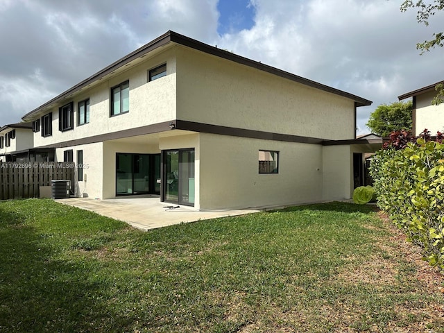 6711 SW 127th Pl, Miami, FL 33183 - back of property with fence, stucco siding, a patio area, central air condition unit, and a yard