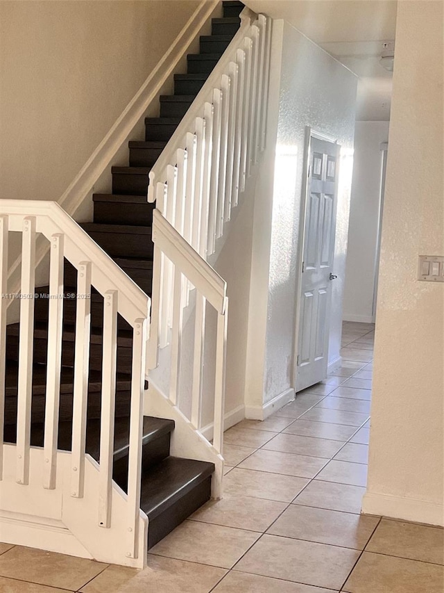 112 SE 28th Ter Unit 4, Homestead, FL 33033 - stairs featuring tile patterned flooring, baseboards, and a textured wall