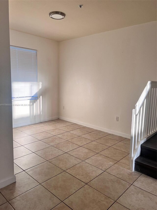 112 SE 28th Ter Unit 4, Homestead, FL 33033 - spare room with stairs, baseboards, and light tile patterned floors