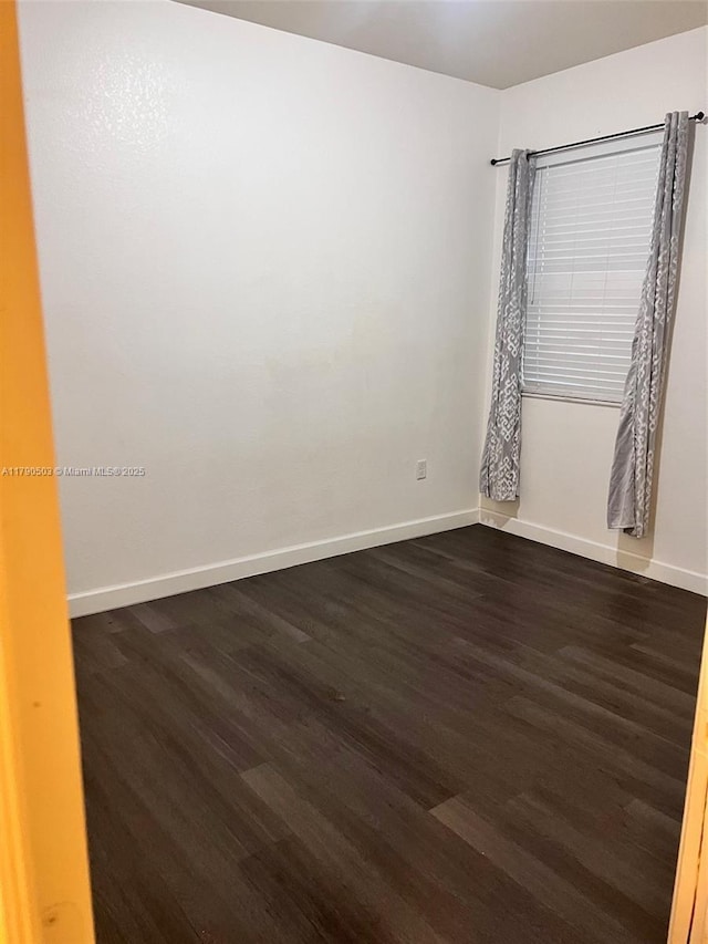 112 SE 28th Ter Unit 4, Homestead, FL 33033 - empty room featuring baseboards and dark wood-style floors