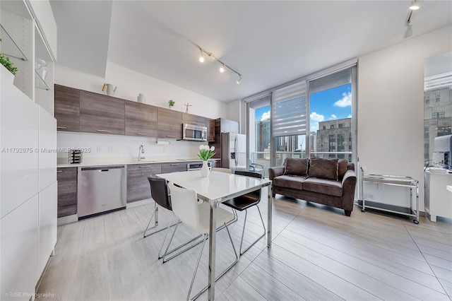151 SE 1st St Unit 1706, Miami, FL 33131 - kitchen featuring light countertops, modern cabinets, stainless steel appliances, and rail lighting