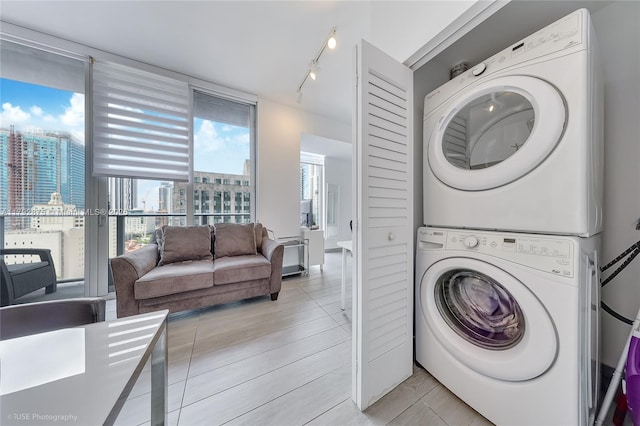 151 SE 1st St Unit 1706, Miami, FL 33131 - clothes washing area featuring laundry area, a view of city, stacked washer / dryer, and track lighting