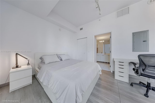 151 SE 1st St Unit 1706, Miami, FL 33131 - bedroom featuring visible vents, light wood-style flooring, and electric panel