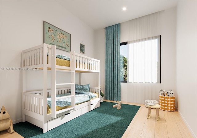 bedroom featuring baseboards, recessed lighting, and wood finished floors