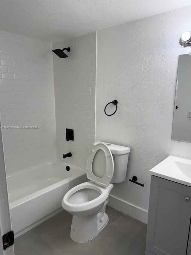 bathroom with tile patterned flooring, baseboards, washtub / shower combination, and toilet