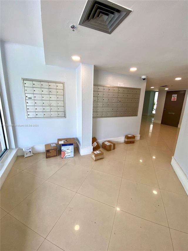 1700 NW N River Dr Unit 501, Miami, FL 33125 - hall with baseboards, visible vents, tile patterned flooring, and mail area