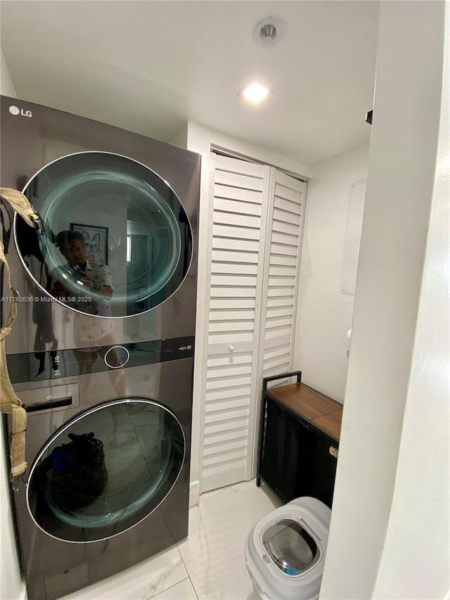 1700 NW N River Dr Unit 501, Miami, FL 33125 - laundry area with stacked washer and dryer, laundry area, and marble finish floor