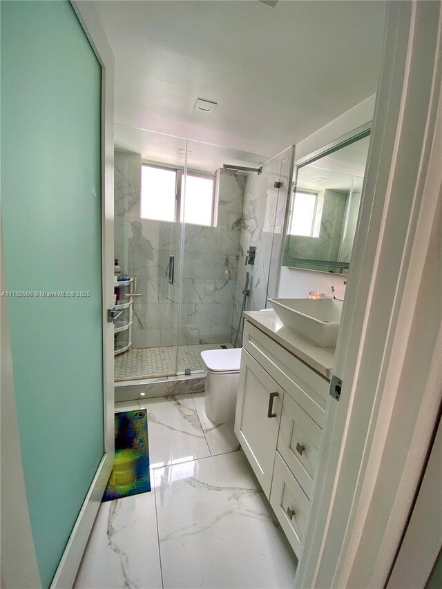 1700 NW N River Dr Unit 501, Miami, FL 33125 - bathroom featuring vanity, marble finish floor, a marble finish shower, and toilet