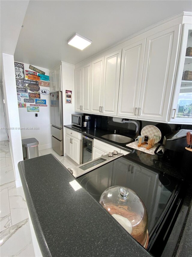 1700 NW N River Dr Unit 501, Miami, FL 33125 - kitchen featuring white cabinets, a sink, beverage cooler, marble finish floor, and stainless steel appliances