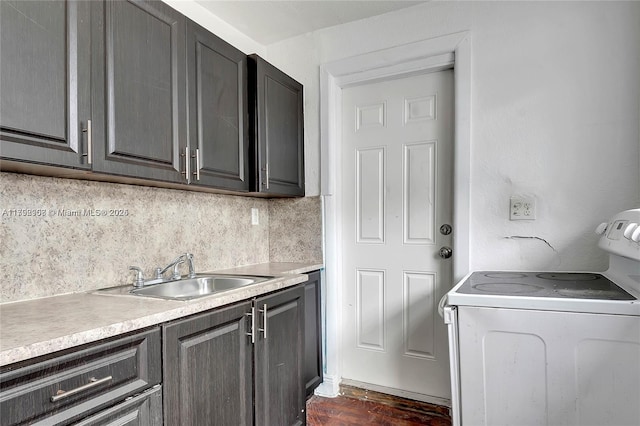 laundry area with cabinet space, dark wood-style floors, and a sink