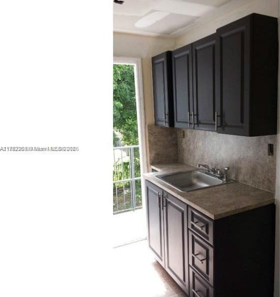 kitchen with a sink and decorative backsplash