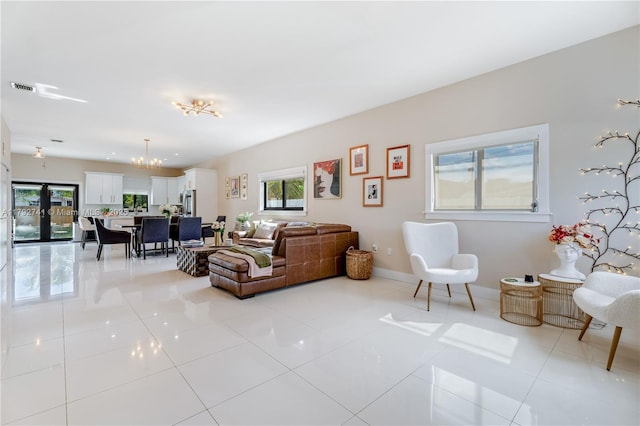 6470 SW 33rd St, Miami, FL 33155 - living area with plenty of natural light, light tile patterned flooring, a chandelier, and baseboards