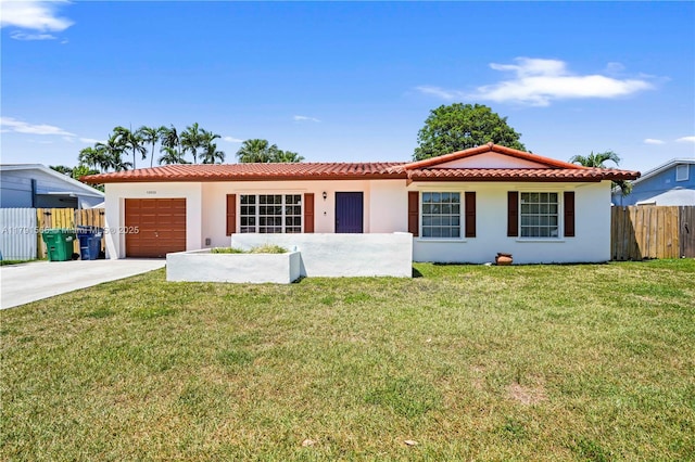 view of front facade with fence, an attached garage, driveway, and stucco siding