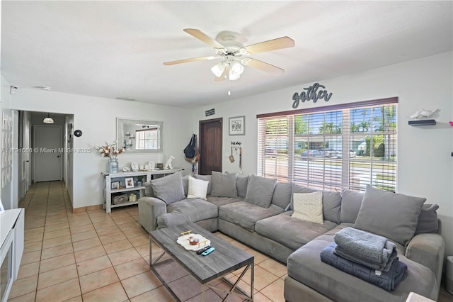 living area with ceiling fan and light tile patterned floors