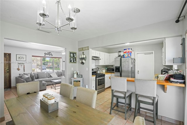 dining area featuring an inviting chandelier and light tile patterned floors
