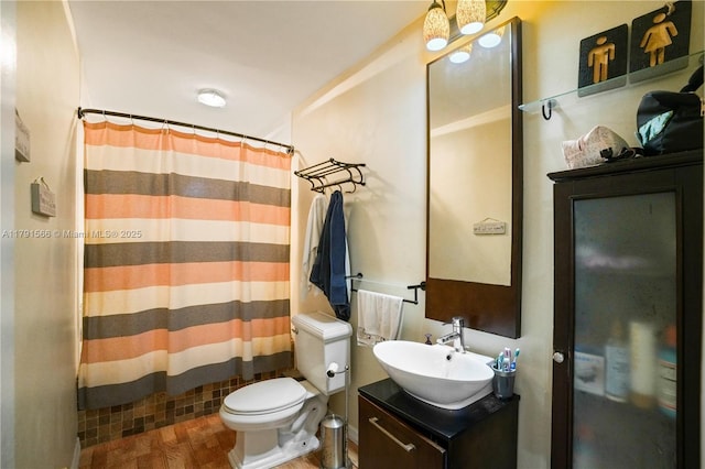 bathroom with vanity, a shower with shower curtain, wood finished floors, and toilet